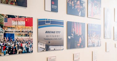 A gallery wall of various images celebrating Boeing's 50 years in China.