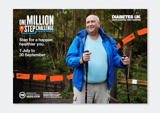 man walking in woods with hiking poles 