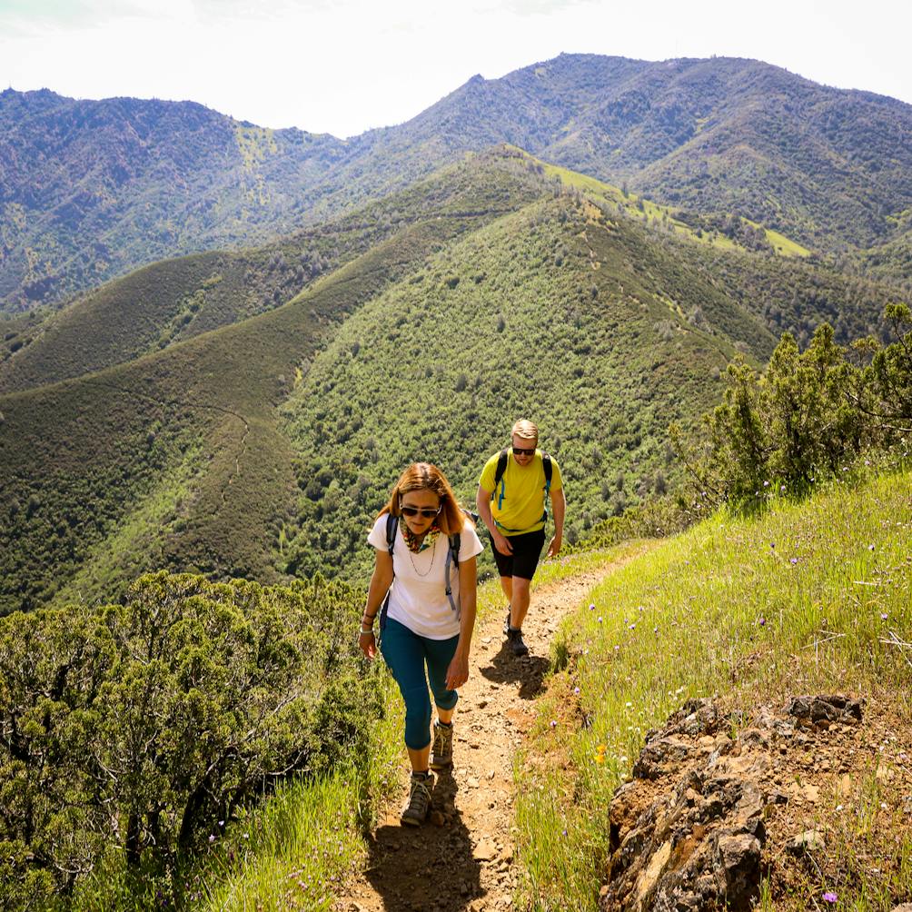 Two hikers walk a hiking trail to Eagle Peak at Mount Diablo State Park 